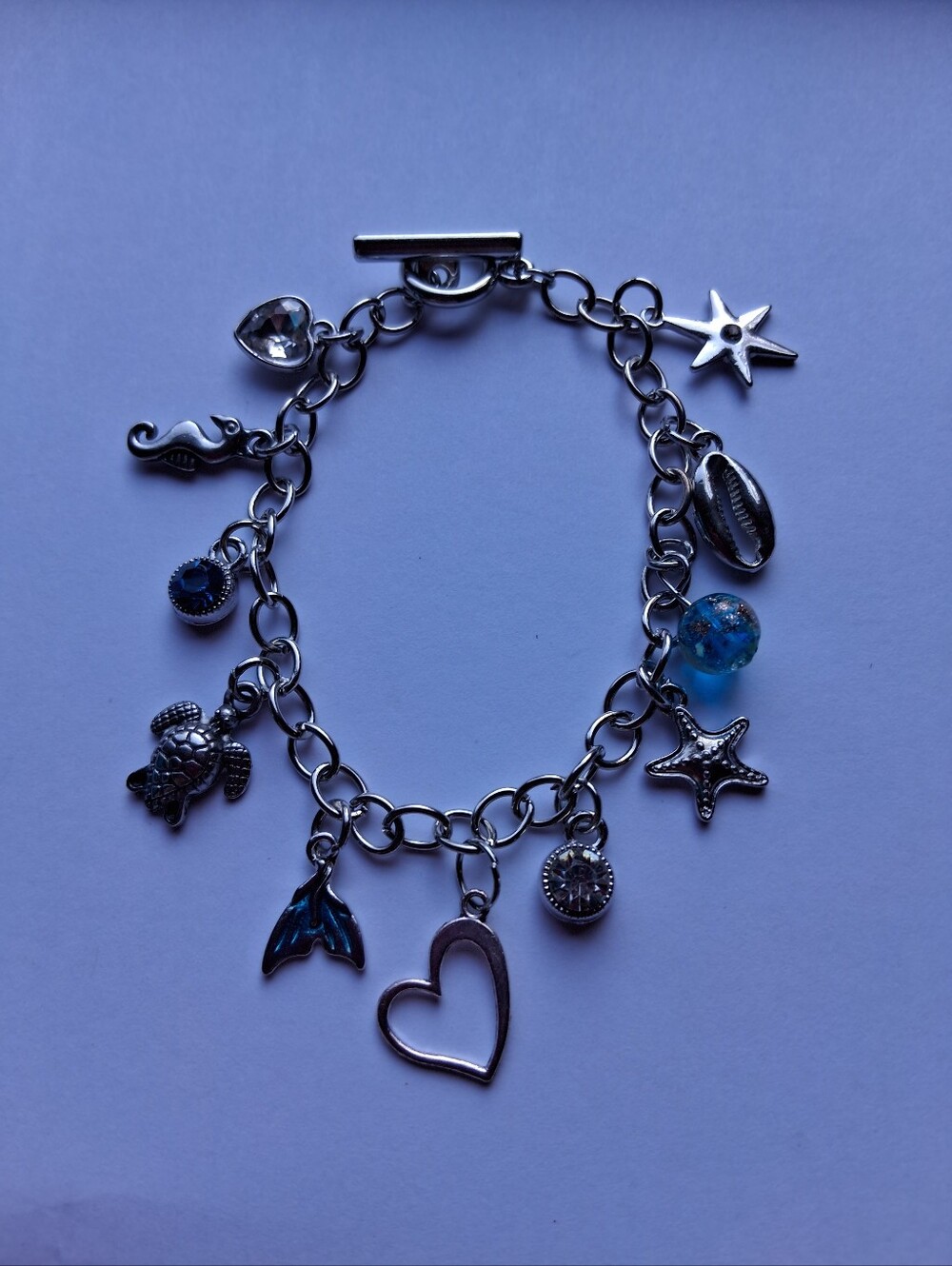 Hand Crafted Silver-tone Ocean Charm Bracelet with Blue Glass Bead